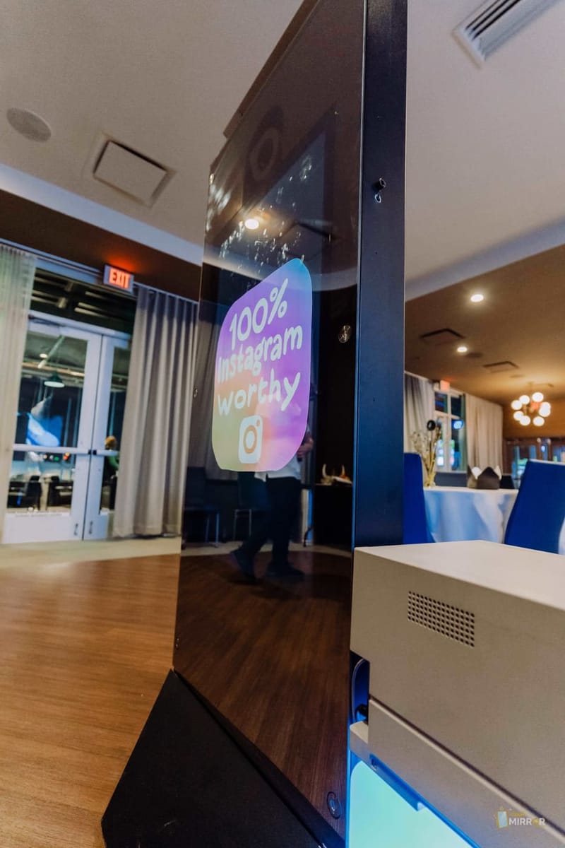 Mirror X photo booth — sleek frameless mirror with animated welcome screen
