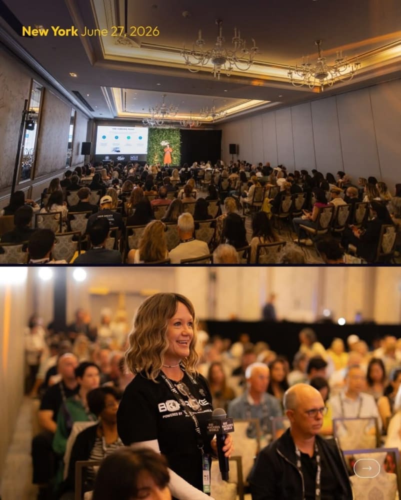 Full audience at a conference styled with greenery wall backdrops