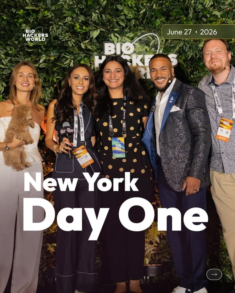 Group photograph taken against a greenery wall at a New York conference