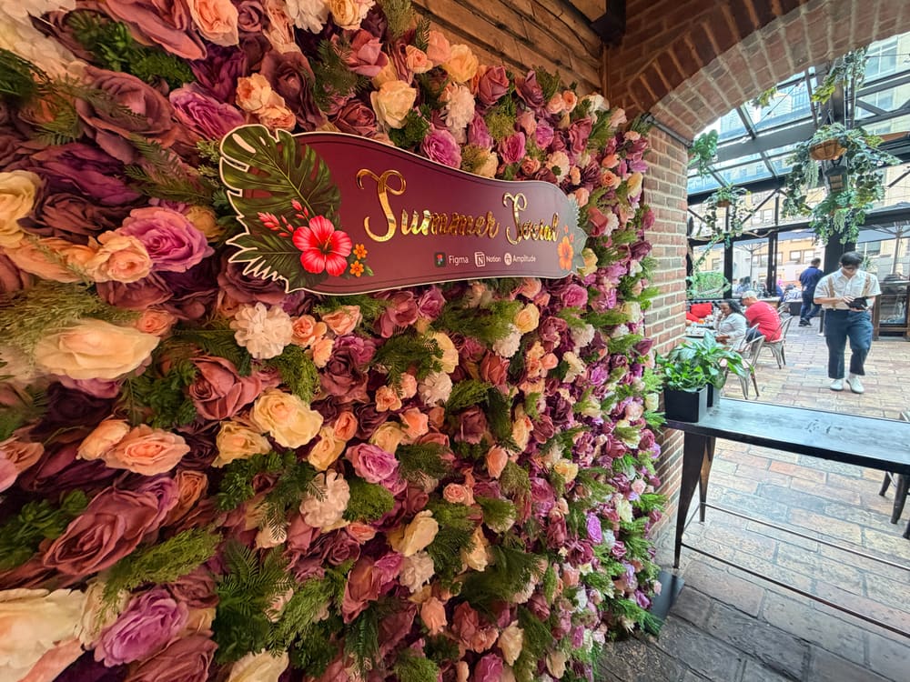 Close view of the Summer Social sign set into a mauve rose wall
