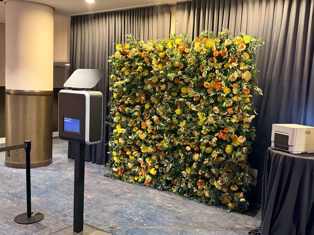 Yellow and orange rose wall with photo booth and printer station set up