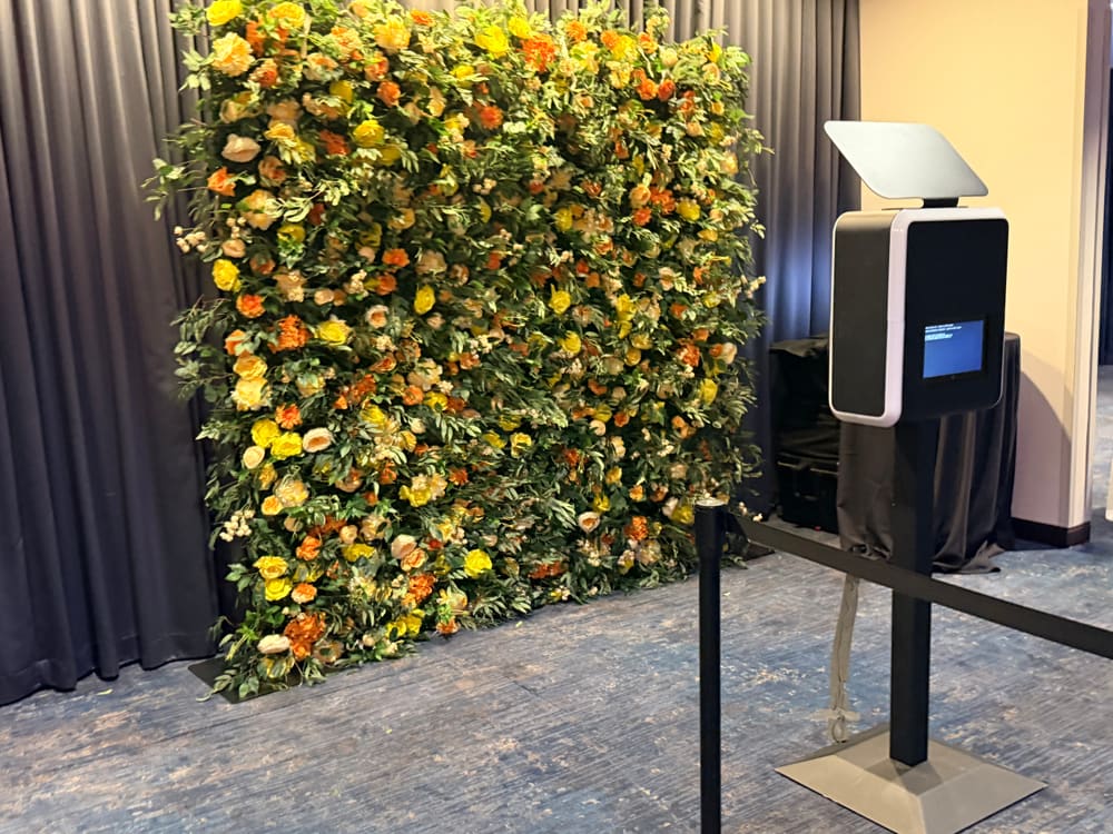 Citrus rose wall paired with an open-air photo booth