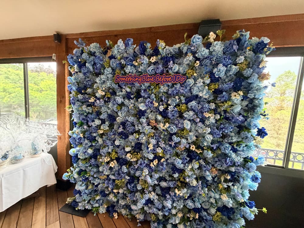 Blue and cream floral wall set beside picture windows for a bridal shower