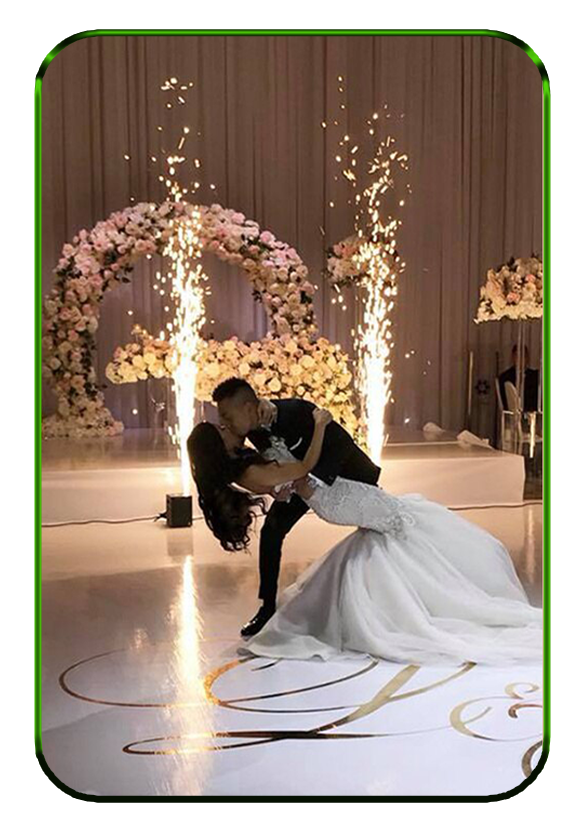 First dance in front of floral arches with cold spark fountains